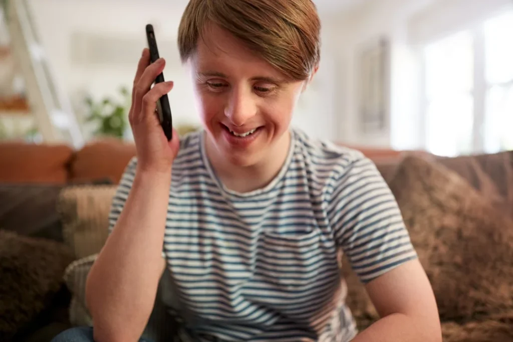 Disabled man using mobile phone
