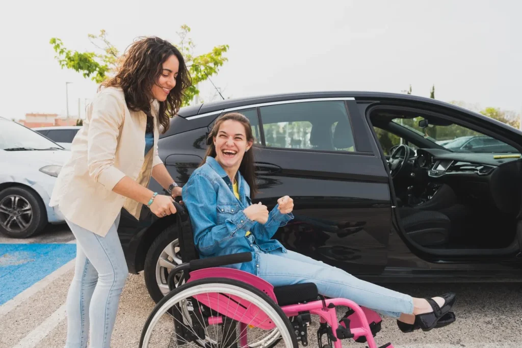 Support worker pushing disabled girl in wheelchair
